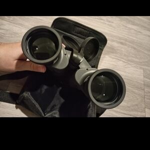 High-quality black binoculars with a protective case